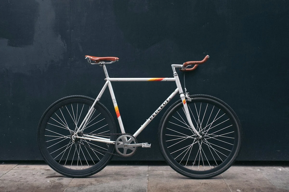 A bicycle resting against a dark wall