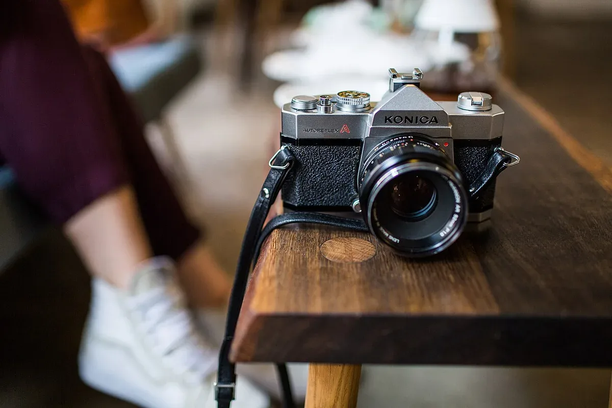 A camera resting on a wooden table