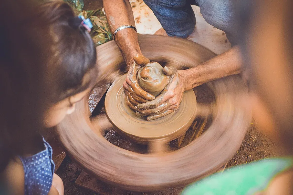 Hands shaping clay