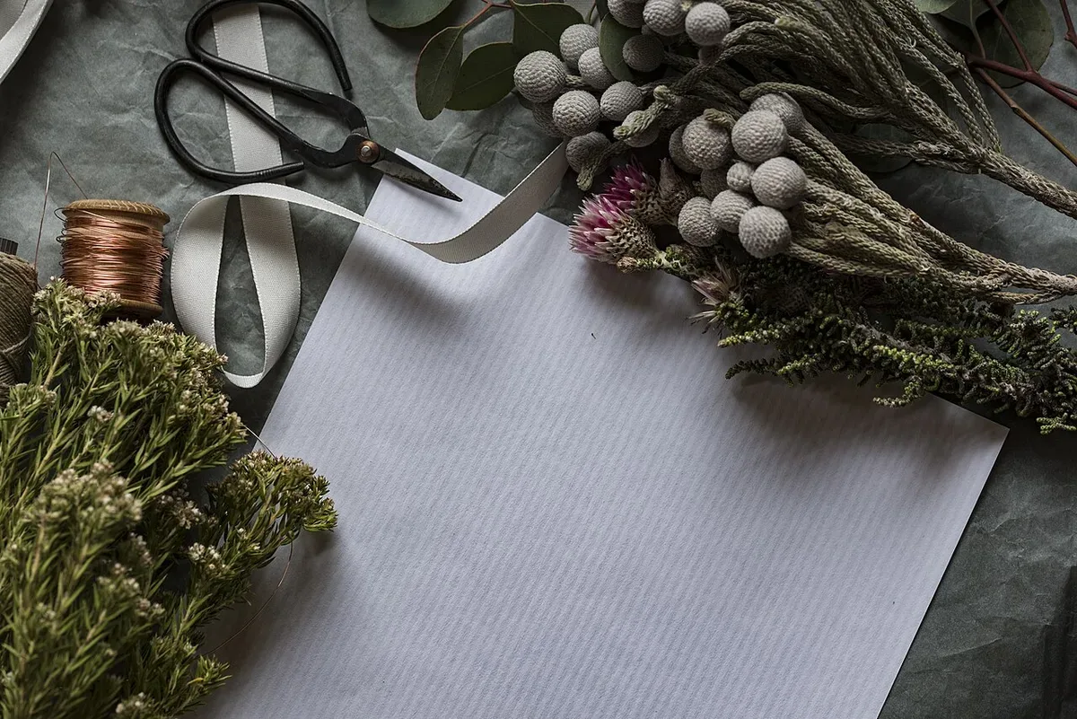 Flowers, scissors and string on a work surface
