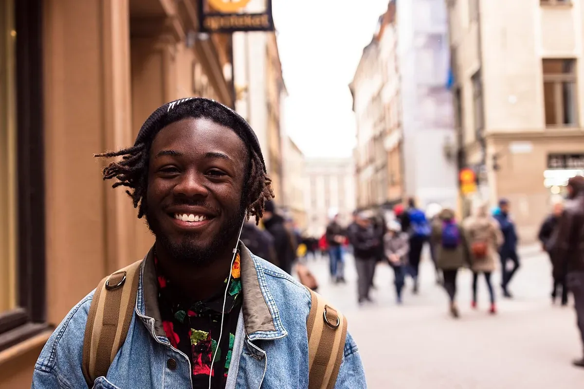A person wearing headphones on a city street