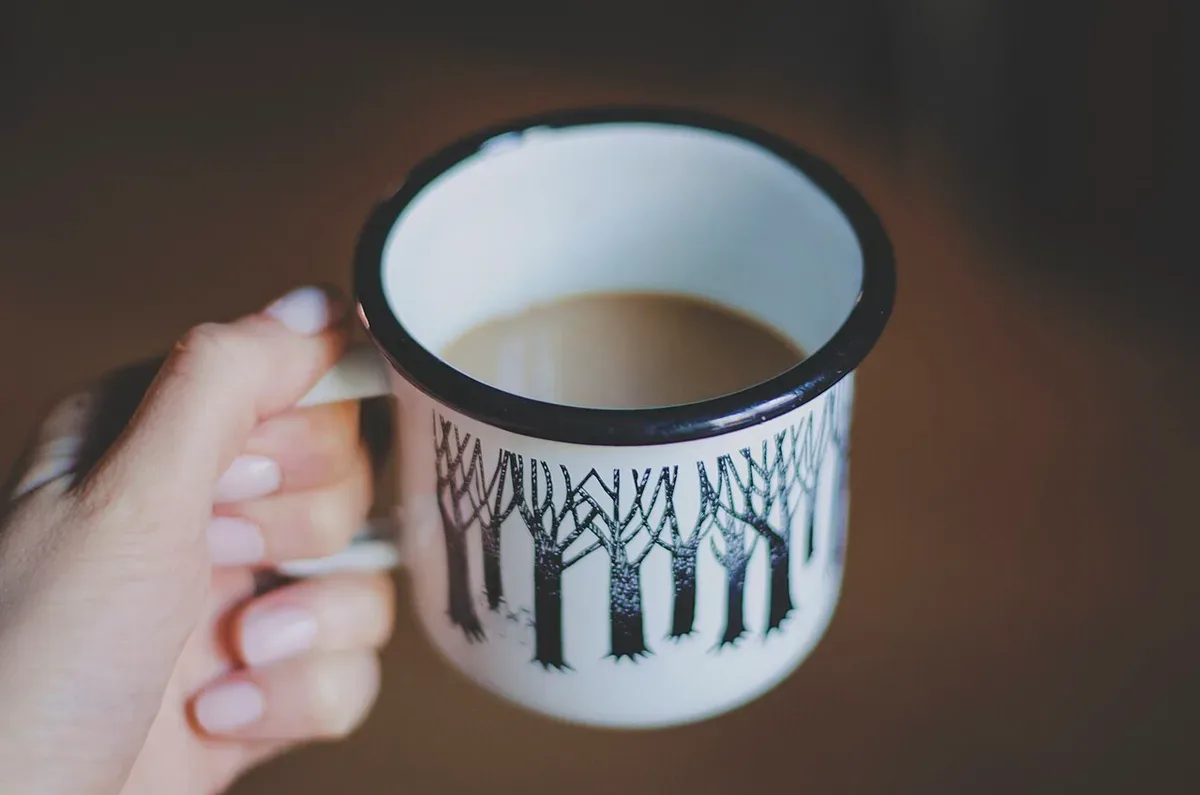 A hand holding a cup of tea