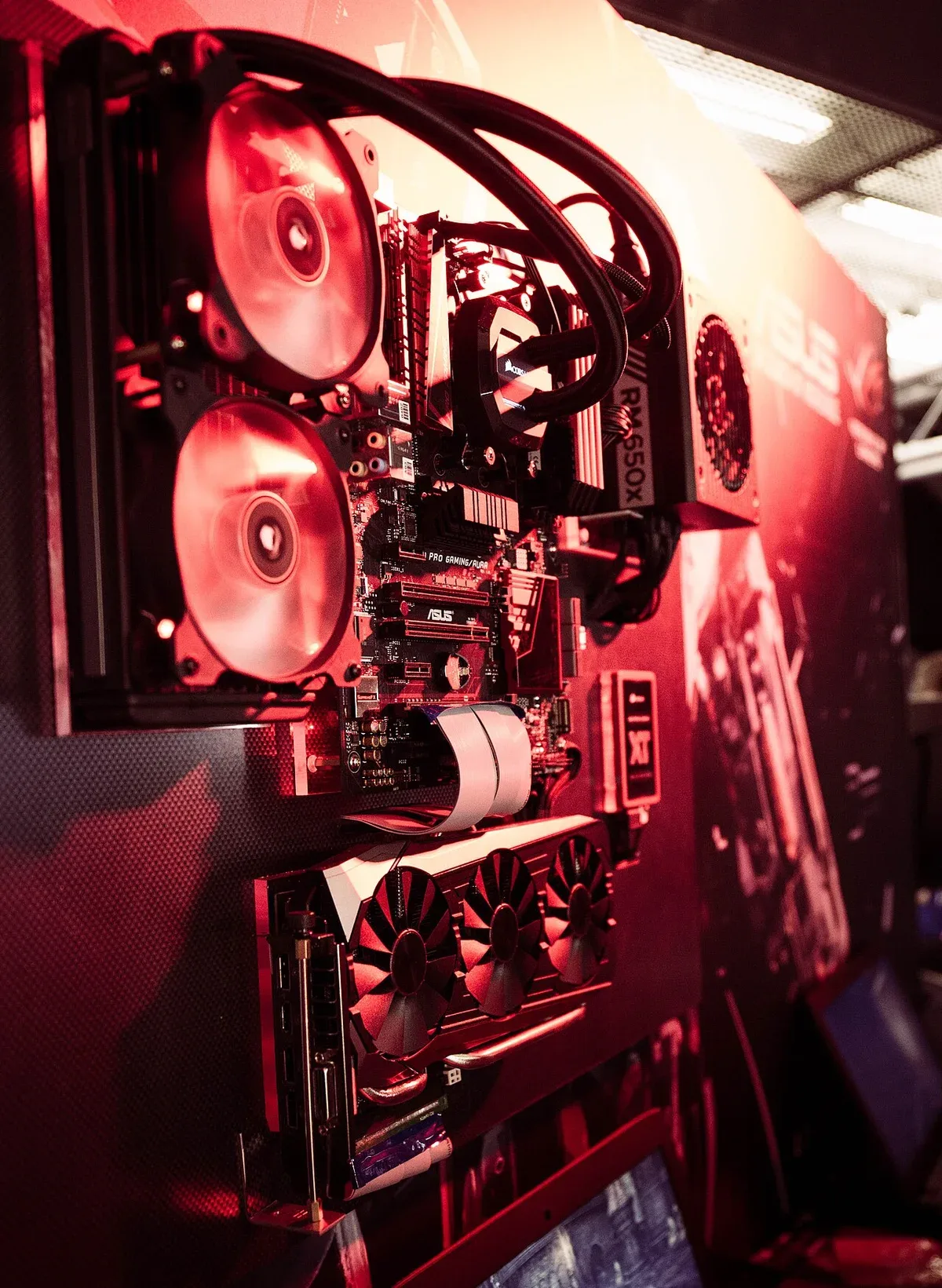 The red-lit fans and components inside a gaming computer