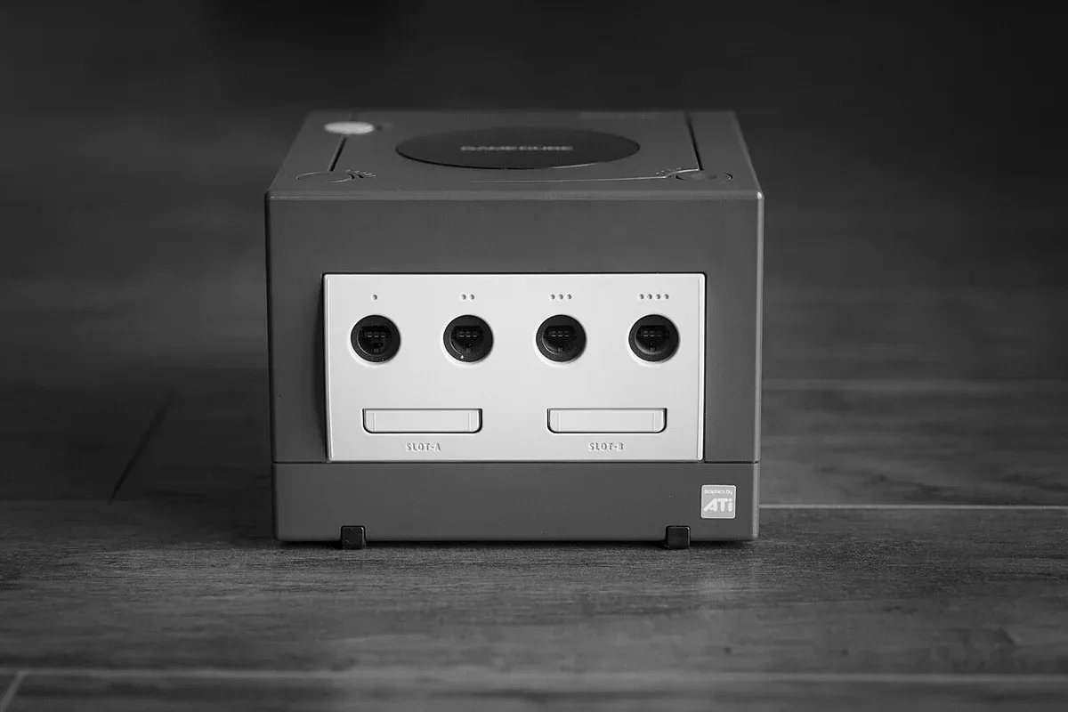 A compact game console photographed against a dark background