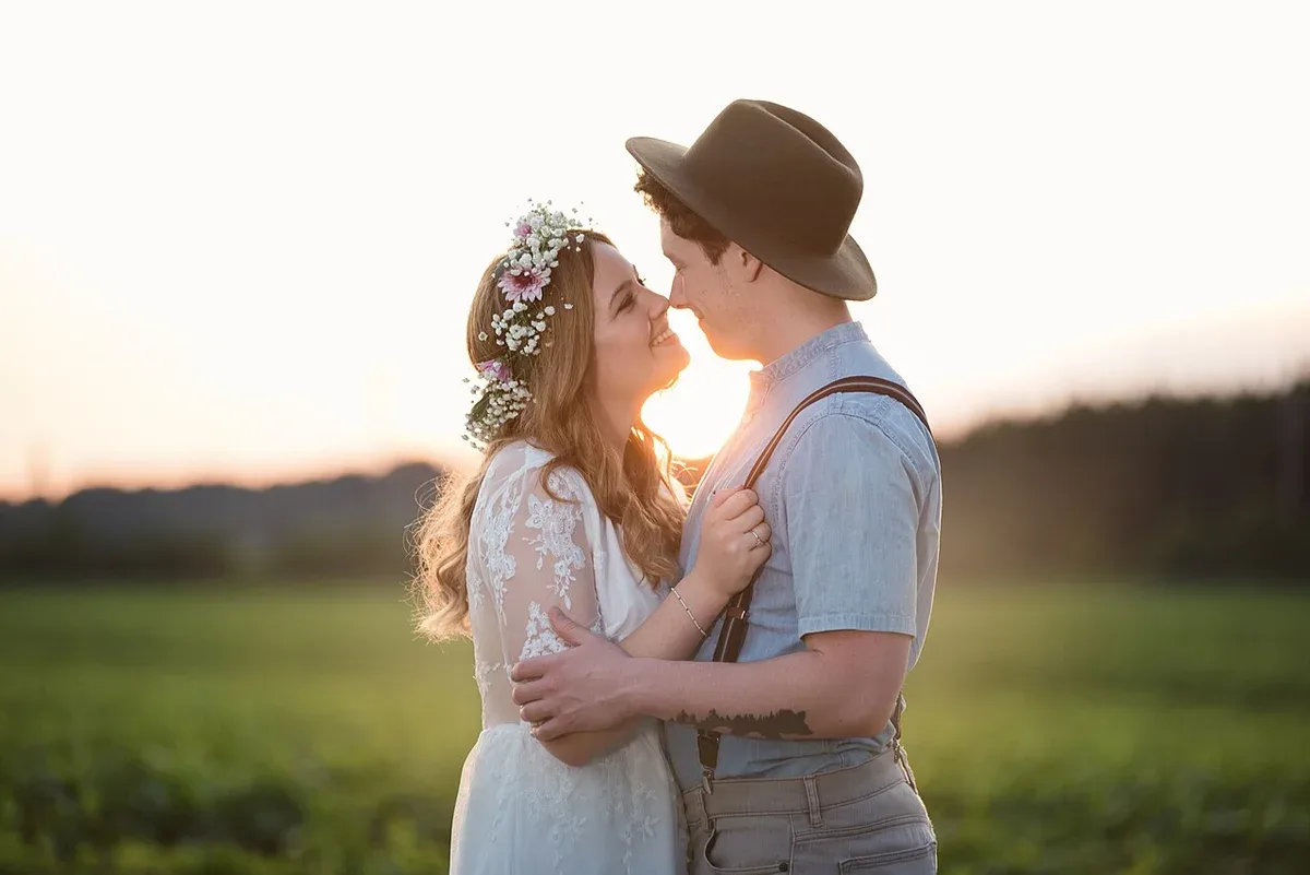 A wedding couple embracing in warm evening light
